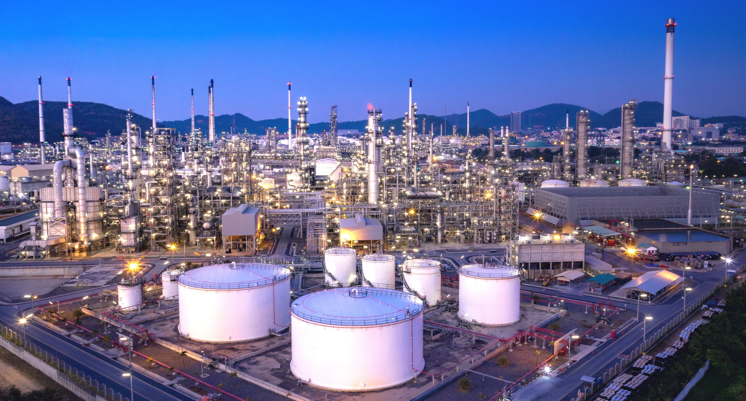 Petrochemical refinery and tank farm illuminated at twilight